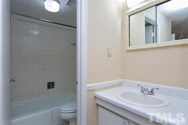 1022 Sandlin Place, Unit A Raleigh, NC 27606 - Photo 8 of 20 a bathroom with a sink and a mirror