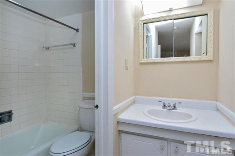 1022 Sandlin Place, Unit A Raleigh, NC 27606 - Photo 9 of 20 a bathroom with a sink toilet and shower