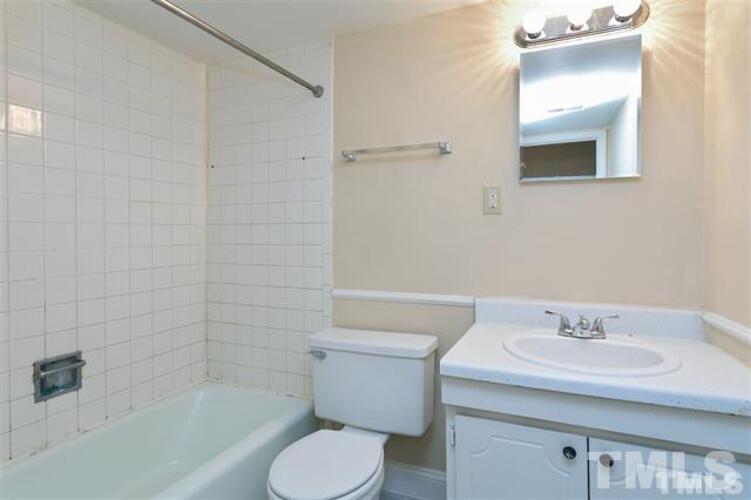 1022 Sandlin Place, Unit A Raleigh, NC 27606 - Photo 10 of 20 a bathroom with a sink toilet and shower
