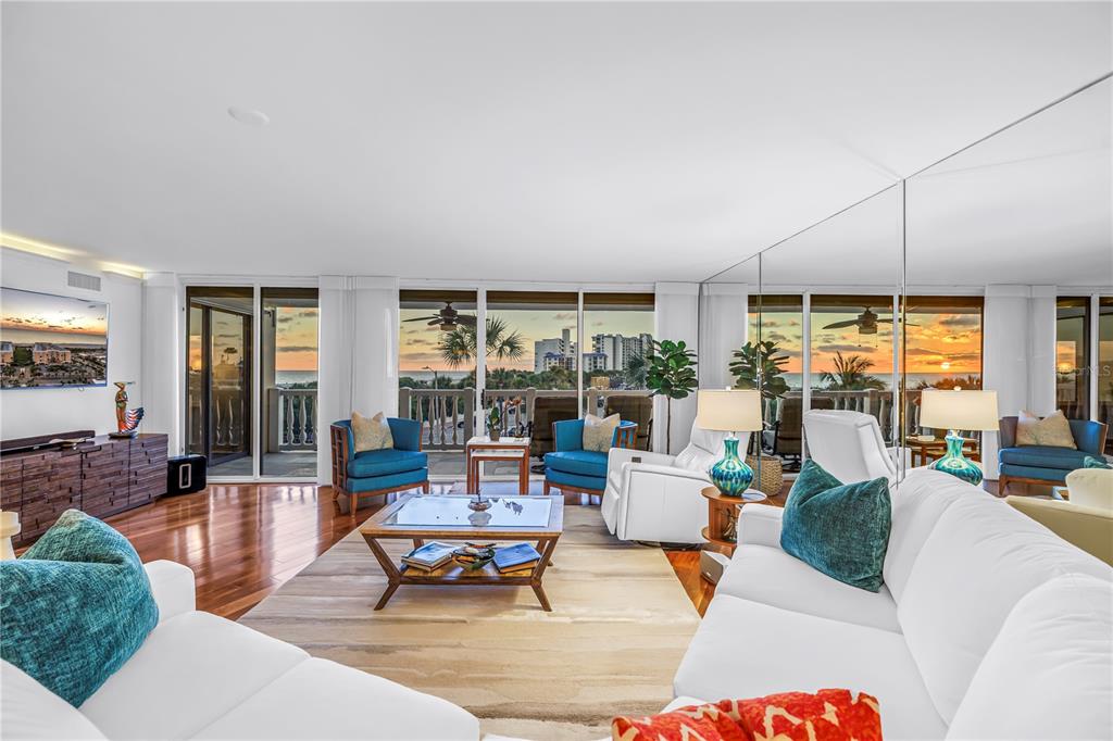 6650 Sunset Way, Unit 207 St. Pete Beach, FL 33706 - Photo 16 of 57 a living room with furniture and a large window