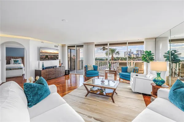 a living room with furniture and wooden floor
