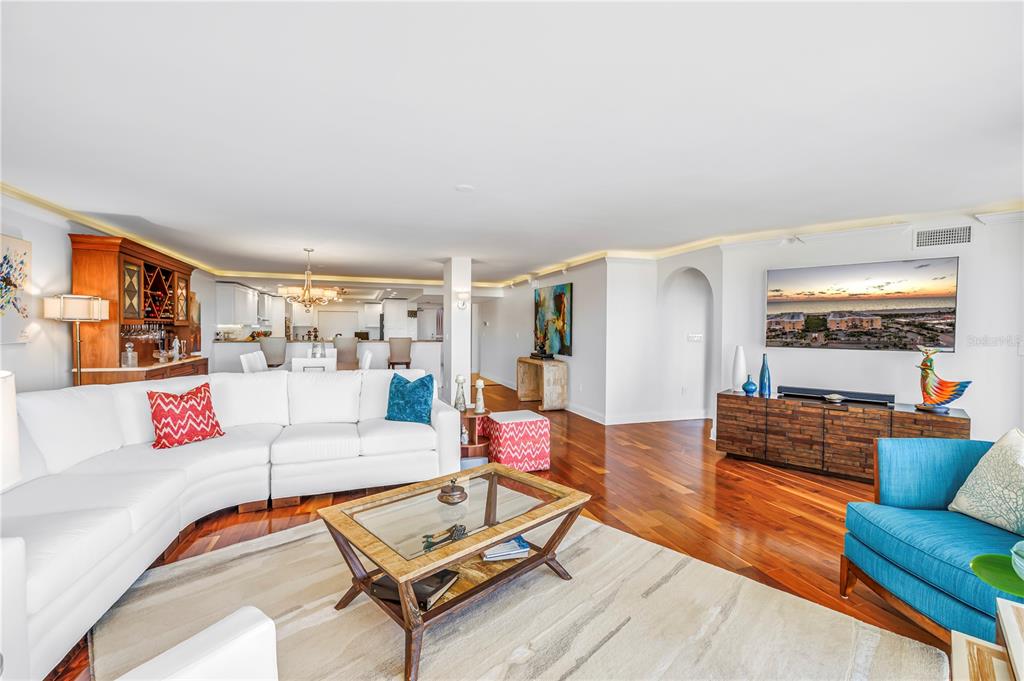 6650 Sunset Way, Unit 207 St. Pete Beach, FL 33706 - Photo 18 of 57 a living room with furniture and wooden floor
