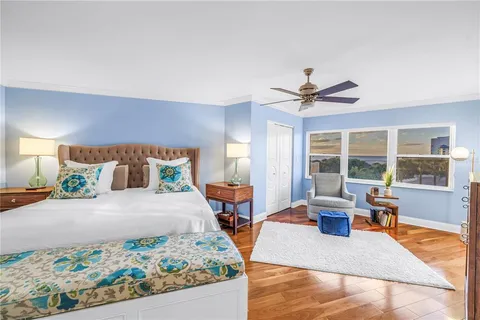 a bedroom with bed and a chandelier