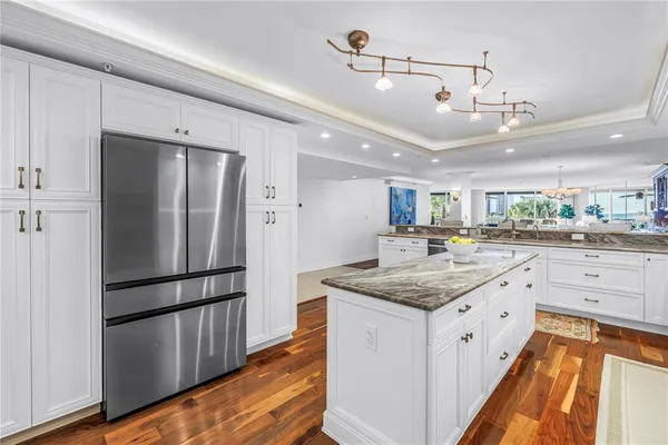 a kitchen with a refrigerator and cabinets