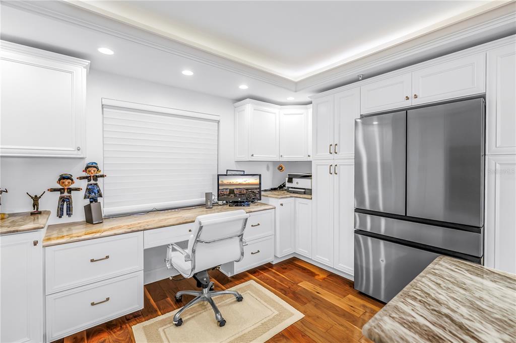 6650 Sunset Way, Unit 207 St. Pete Beach, FL 33706 - Photo 9 of 57 a kitchen with a refrigerator and cabinets