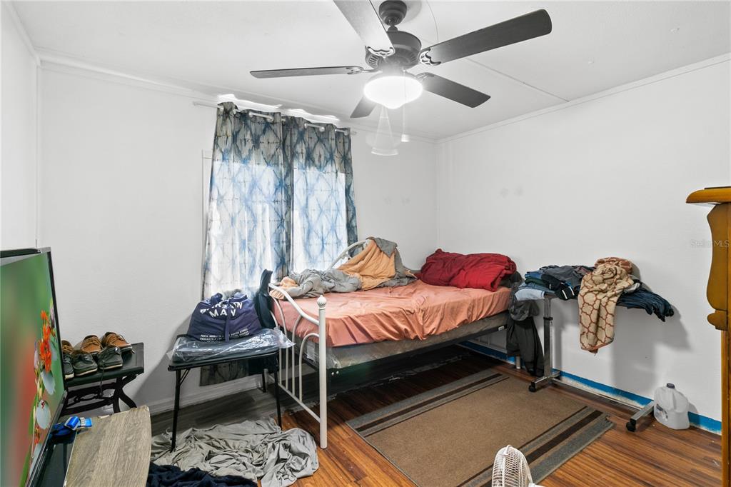 18312 16th Avenue Orlando, FL 32833 - Photo 14 of 26 a bedroom with a bed and a chandelier