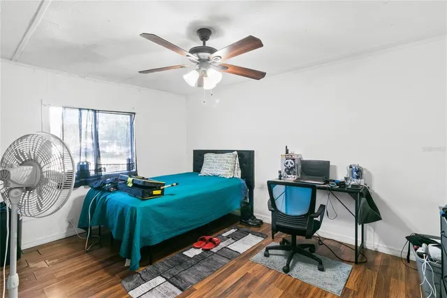 a bedroom with bed and a chandelier