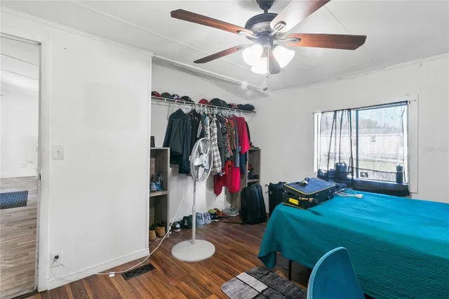 a bed room with a bed mirror and a window