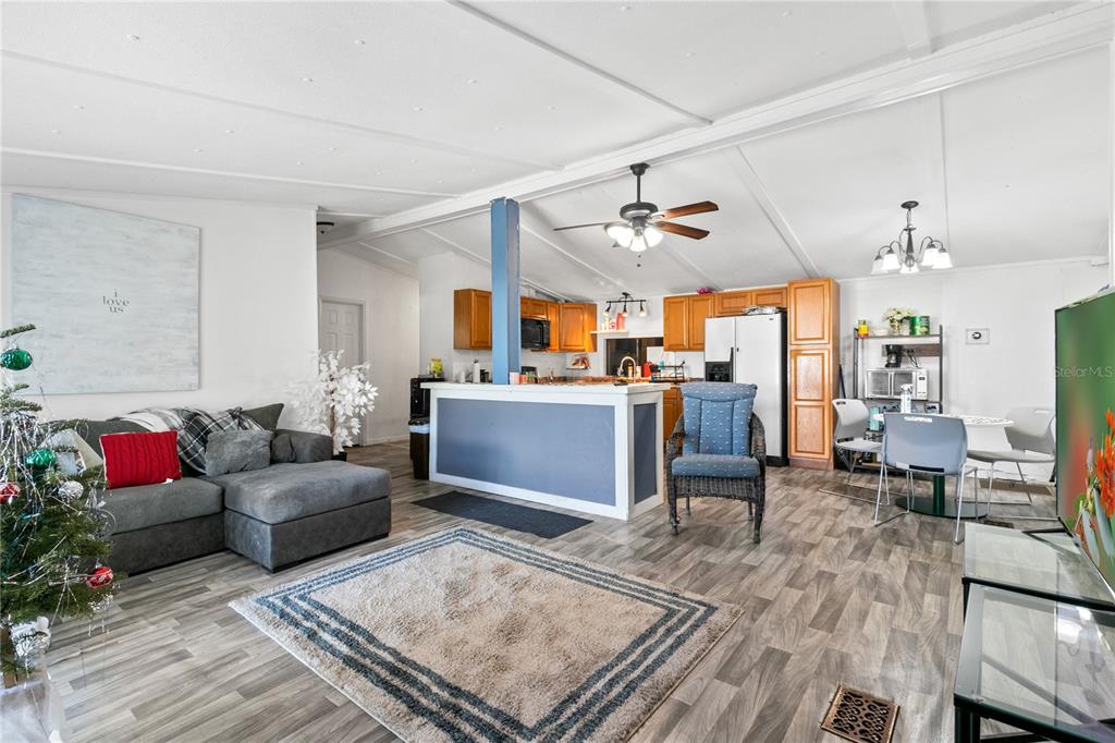 18312 16th Avenue Orlando, FL 32833 - Photo 3 of 26 a living room with furniture kitchen view and a chandelier