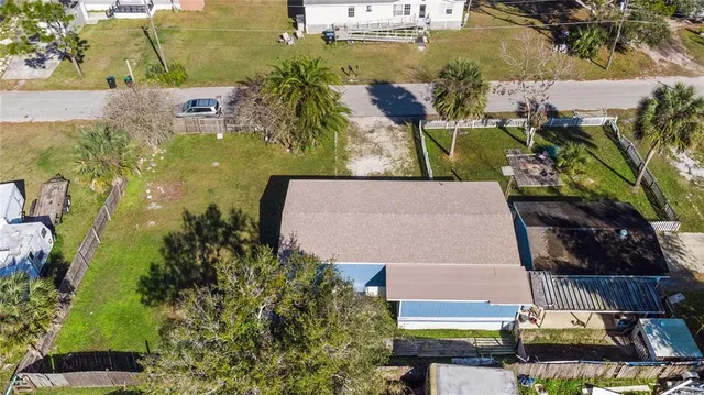 an aerial view of a house with outdoor space