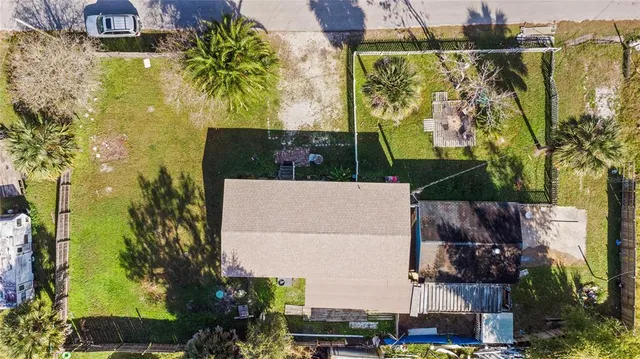 an aerial view of a houses with swimming pool