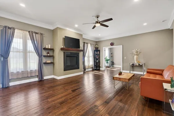 a living room with furniture and wooden floor