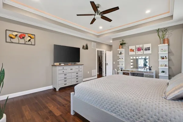 a view of a big room with wooden floor closet and windows