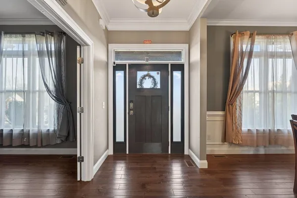 a view of an entryway with wooden floor and door