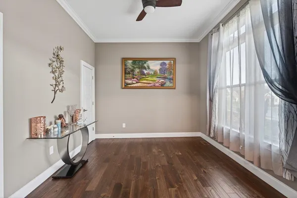a view of room with window and wooden floor