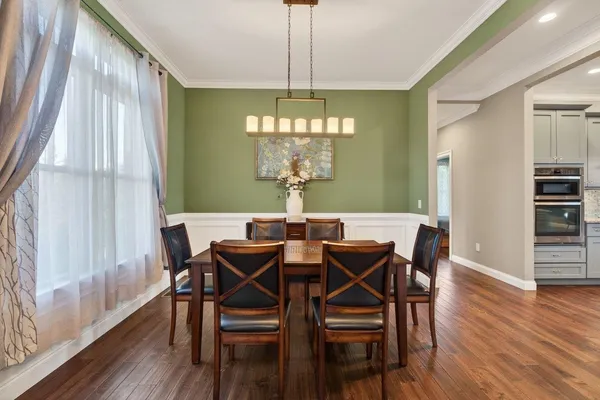 a view of a dining room with furniture window and wooden floor