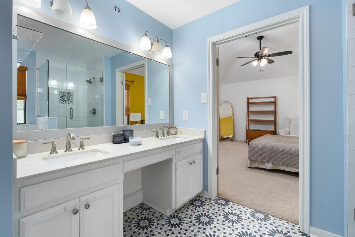 2317 Sycamore Trail Round Rock, TX 78664 - Photo 18 of 31 a en suite bathroom with a double vanity sink and a mirror