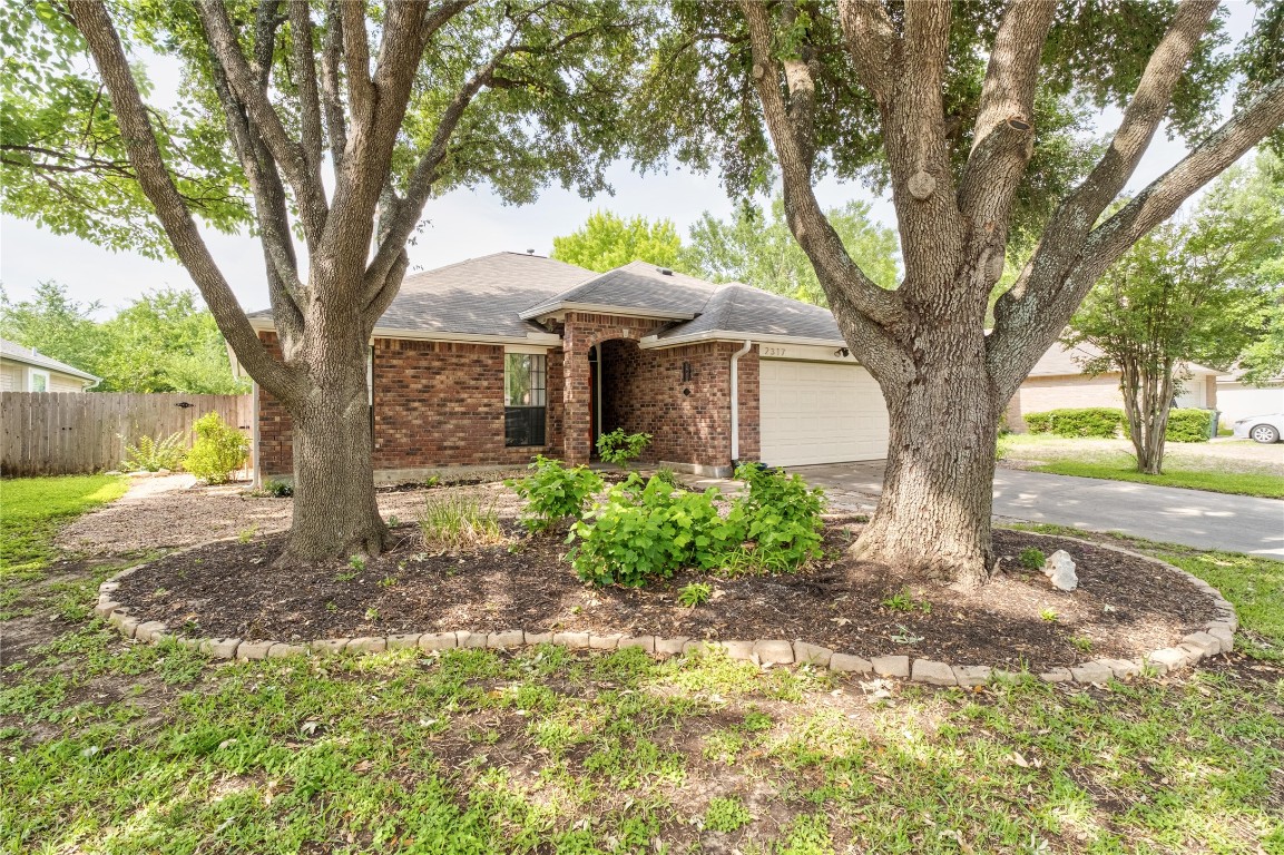 2317 Sycamore Trail Round Rock, TX 78664 - Photo 2 of 31 a front view of a house with garden