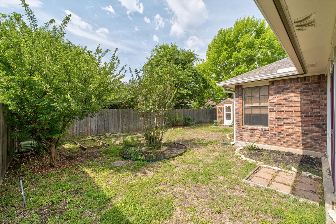 2317 Sycamore Trail Round Rock, TX 78664 - Photo 25 of 31 a backyard of a house with table and chairs
