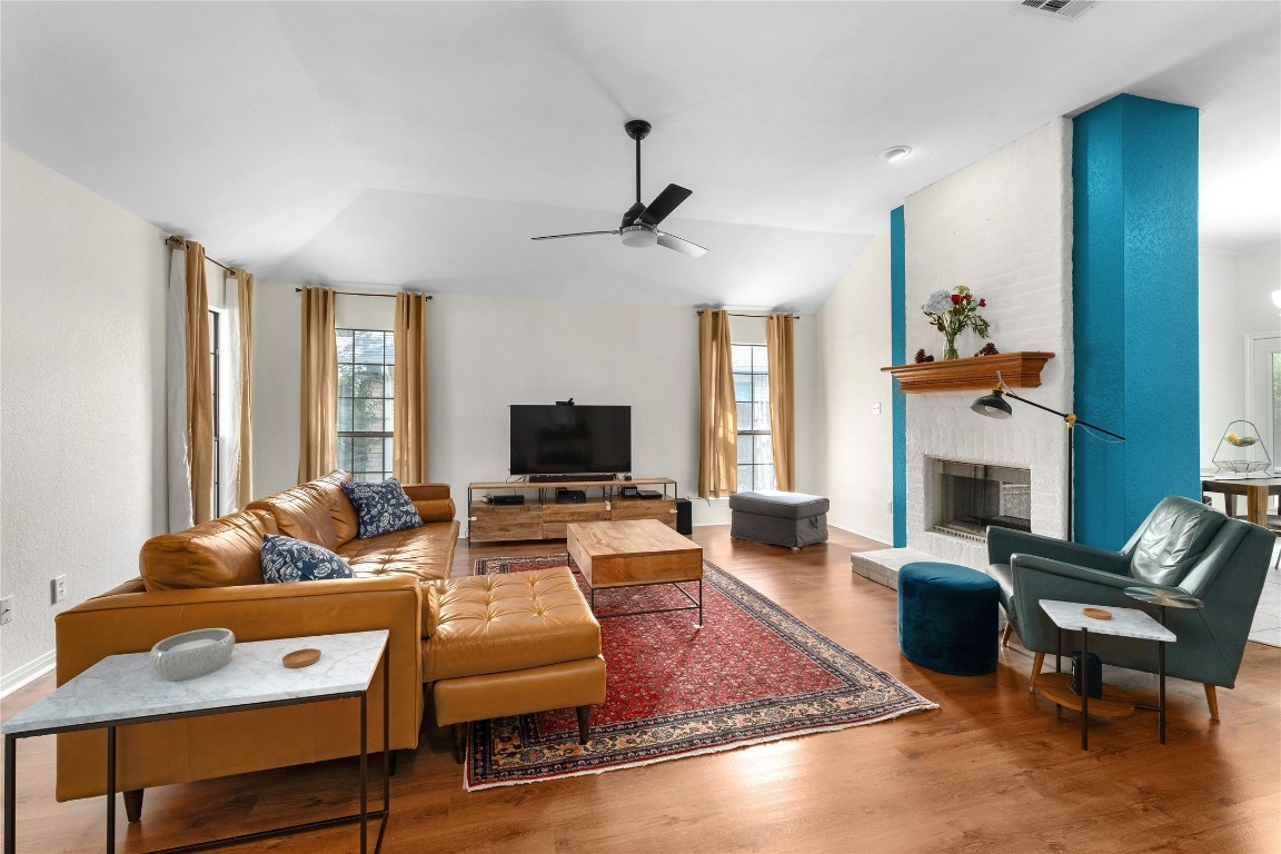 2317 Sycamore Trail Round Rock, TX 78664 - Photo 5 of 31 a living room with furniture a fireplace and a flat screen tv