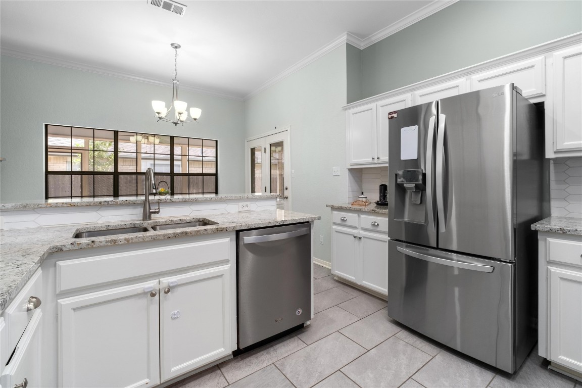 2317 Sycamore Trail Round Rock, TX 78664 - Photo 9 of 31 a kitchen with sink cabinets and stainless steel appliances