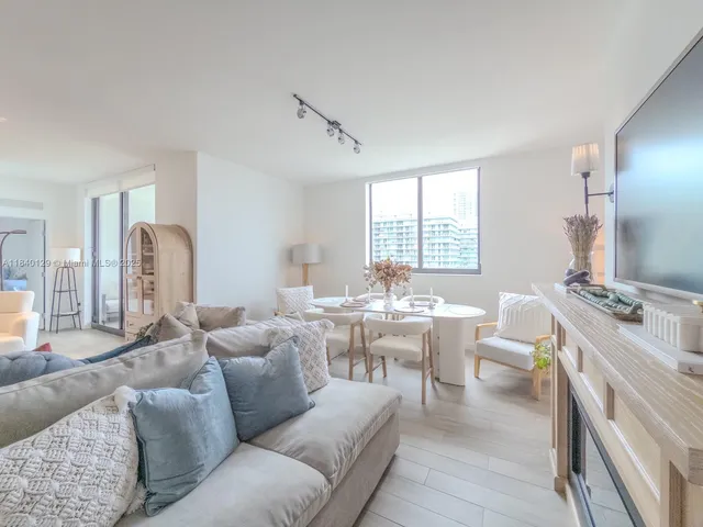 a kitchen with stainless steel appliances kitchen island granite countertop a table and chairs in it