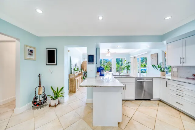 a dining room with kitchen island granite countertop furniture and a potted plant