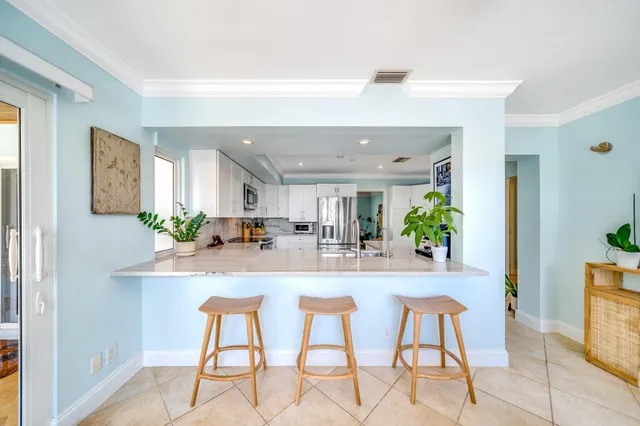 a living room with a fireplace furniture and a large window