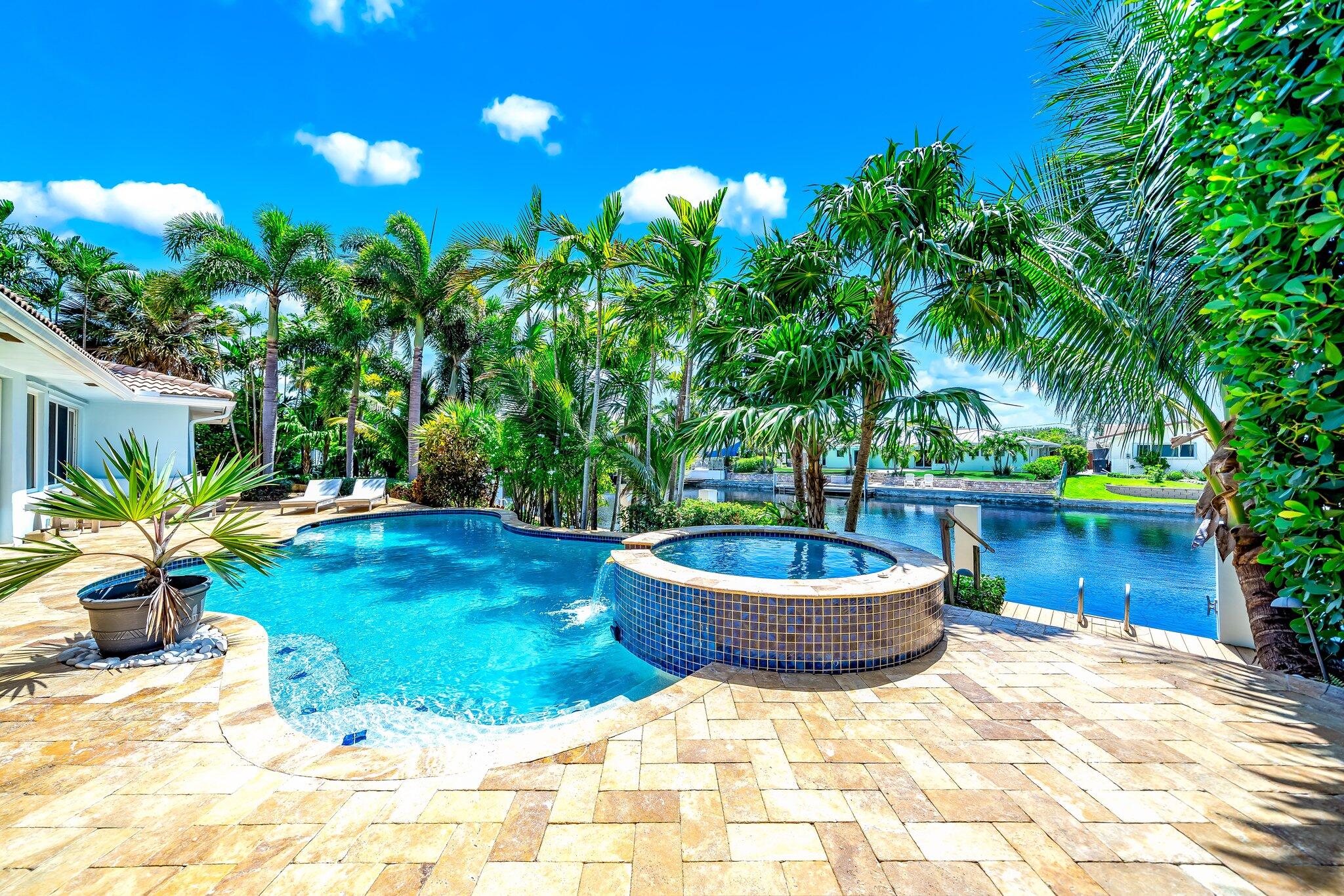 4010 Northeast 25th Avenue Lighthouse Point, FL 33064 - Photo 37 of 57 a view of a backyard with plants and water fountain