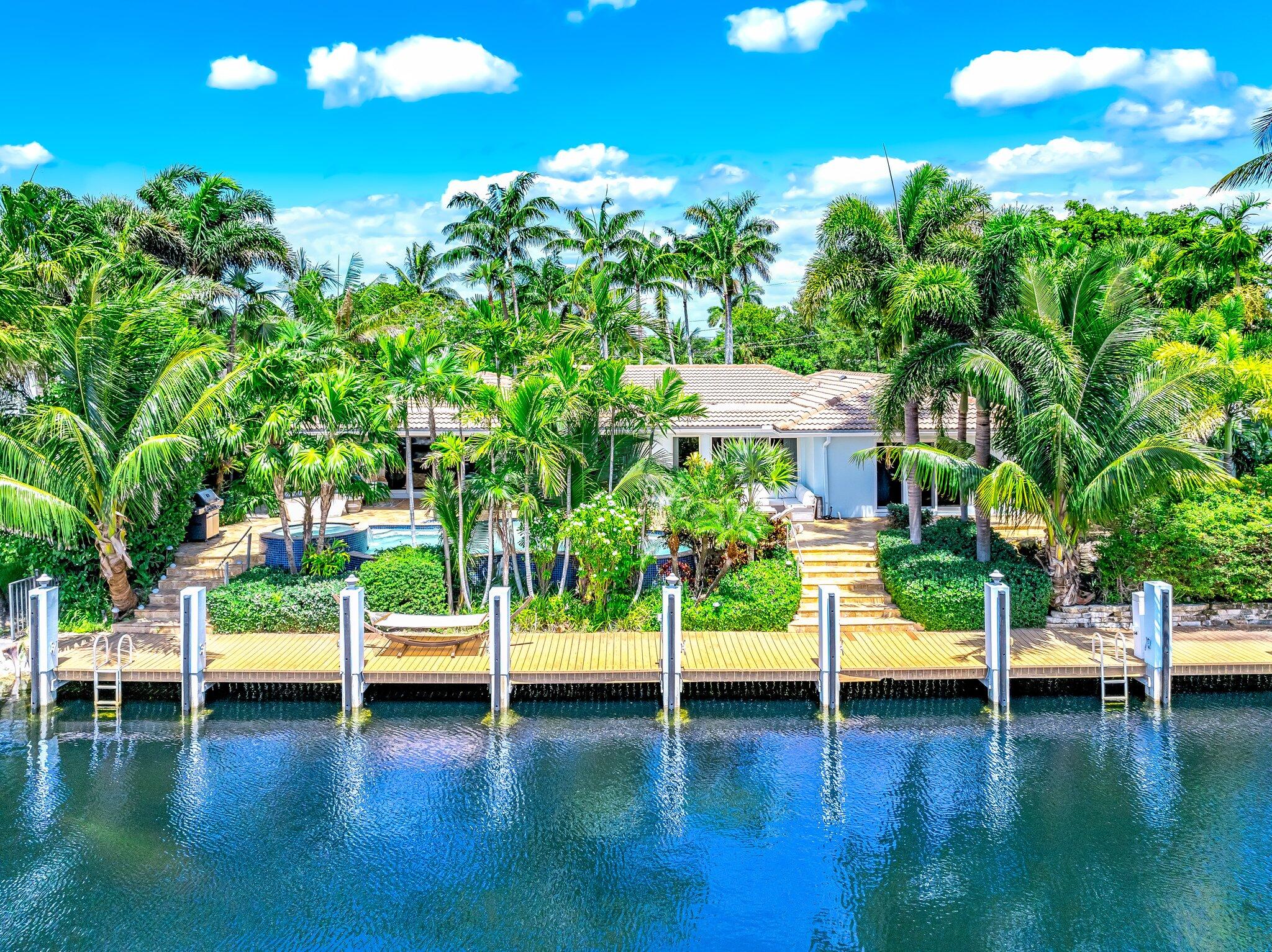 4010 Northeast 25th Avenue Lighthouse Point, FL 33064 - Photo 49 of 57 a view of pool with lawn chairs and plants