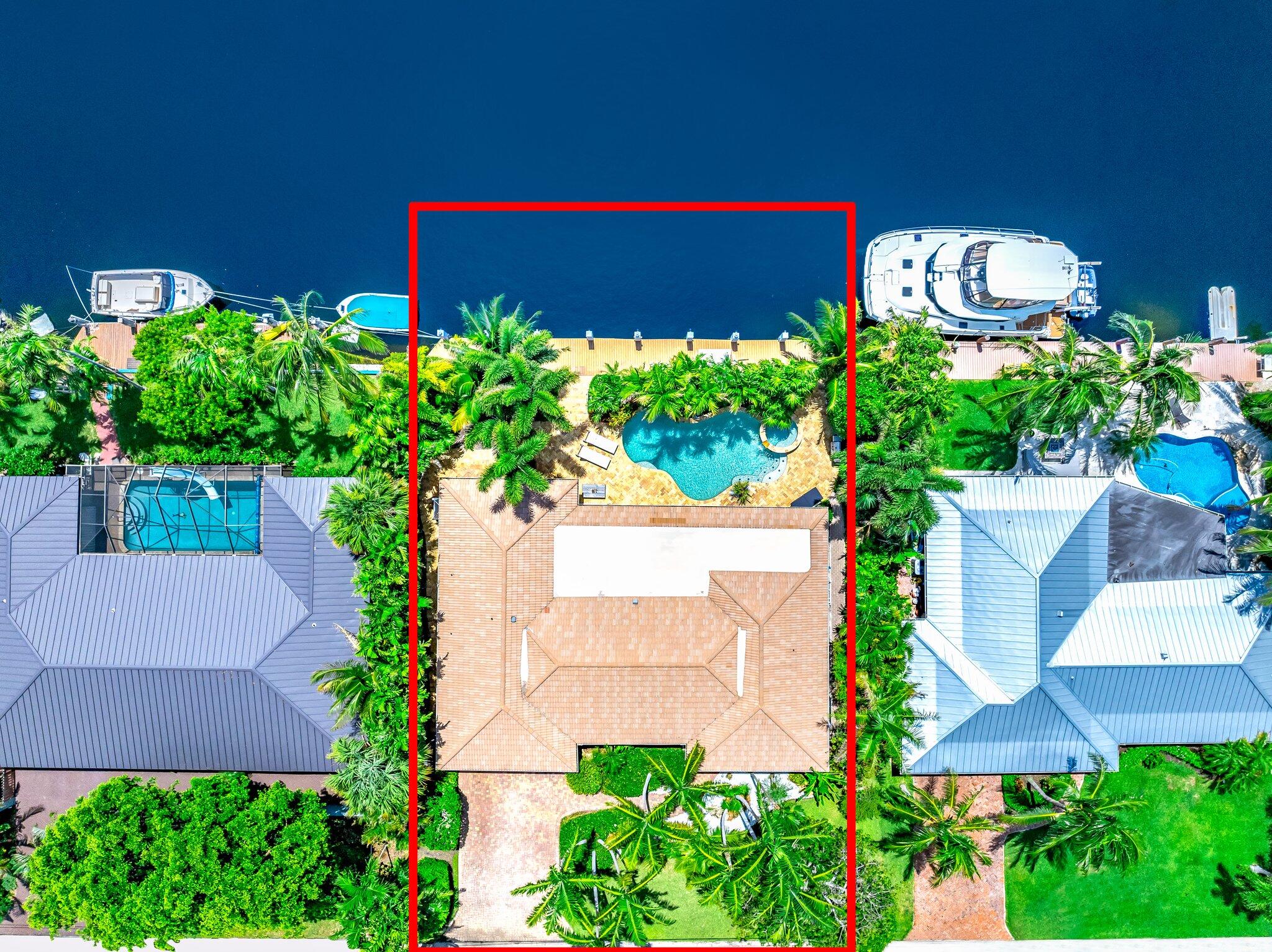 4010 Northeast 25th Avenue Lighthouse Point, FL 33064 - Photo 54 of 57 a view of a garden with a building in the background