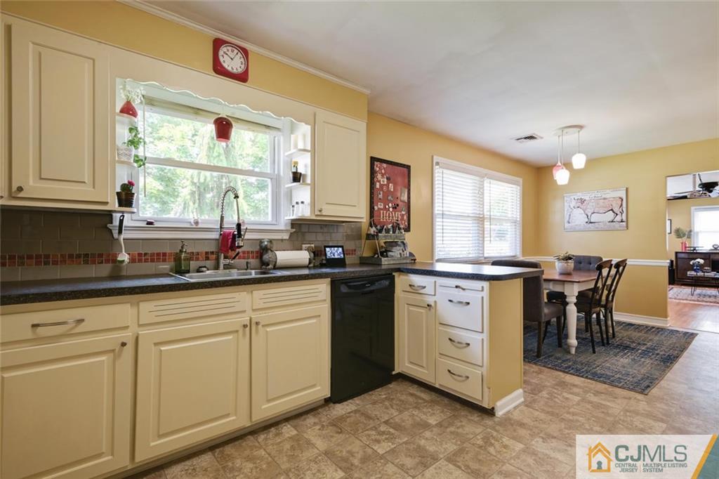 5 Sequola Road Hamilton, NJ 08619 - Photo 8 of 17 a kitchen with granite countertop white cabinets white appliances with a dining table and chairs