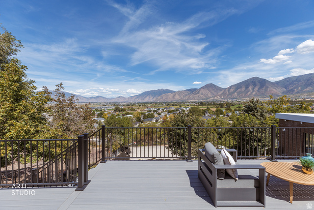 455 Ridge Lane Payson, UT 84651 - Photo 28 of 62 Expansive outdoor deck with composite decking and metal railings, showcasing distant mountain scenery and a community overview