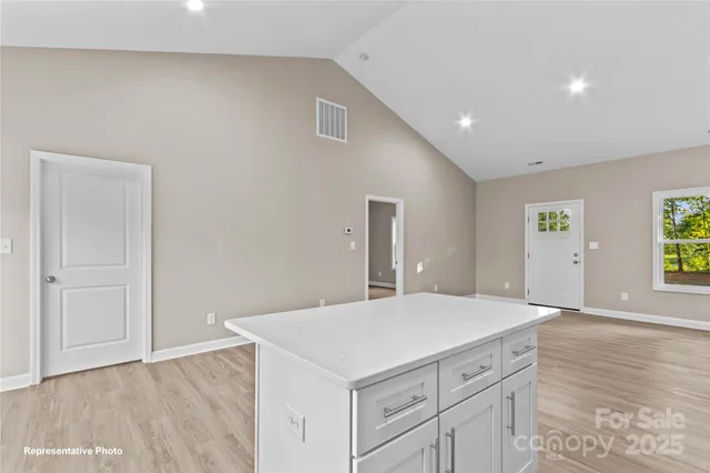 a kitchen with a stove and hallway