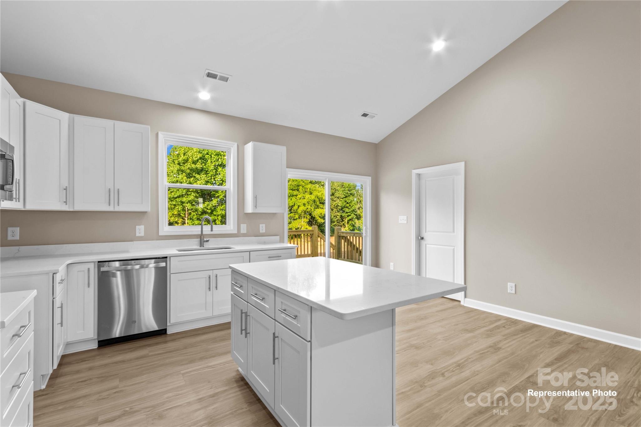 986 Tabor Road Olin, NC 28660 - Photo 13 of 27 a large white kitchen with wooden floor and a sink