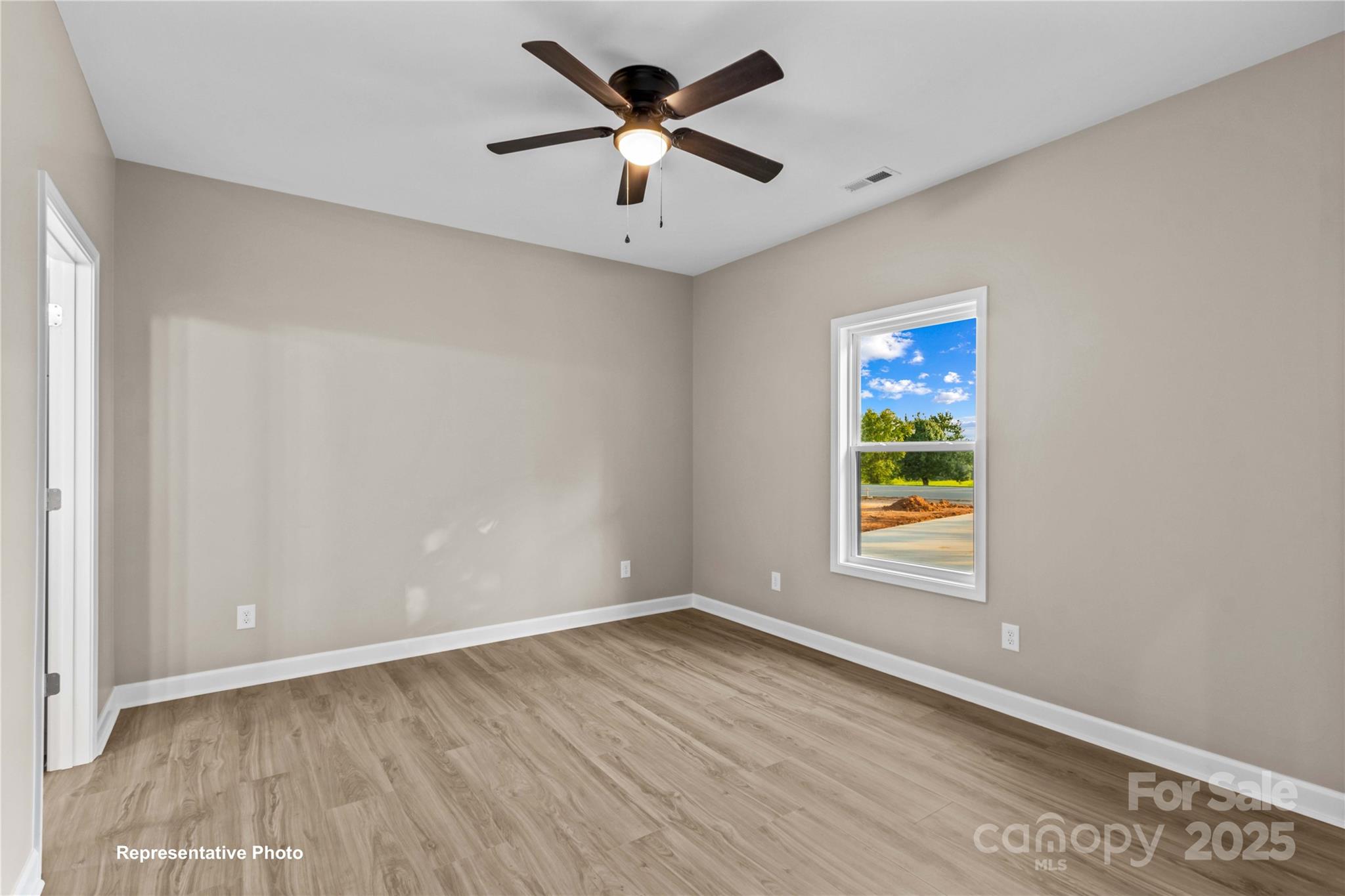 986 Tabor Road Olin, NC 28660 - Photo 14 of 27 an empty room with window and ceiling fan