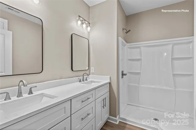 a bathroom with double vanity sinks and a mirror