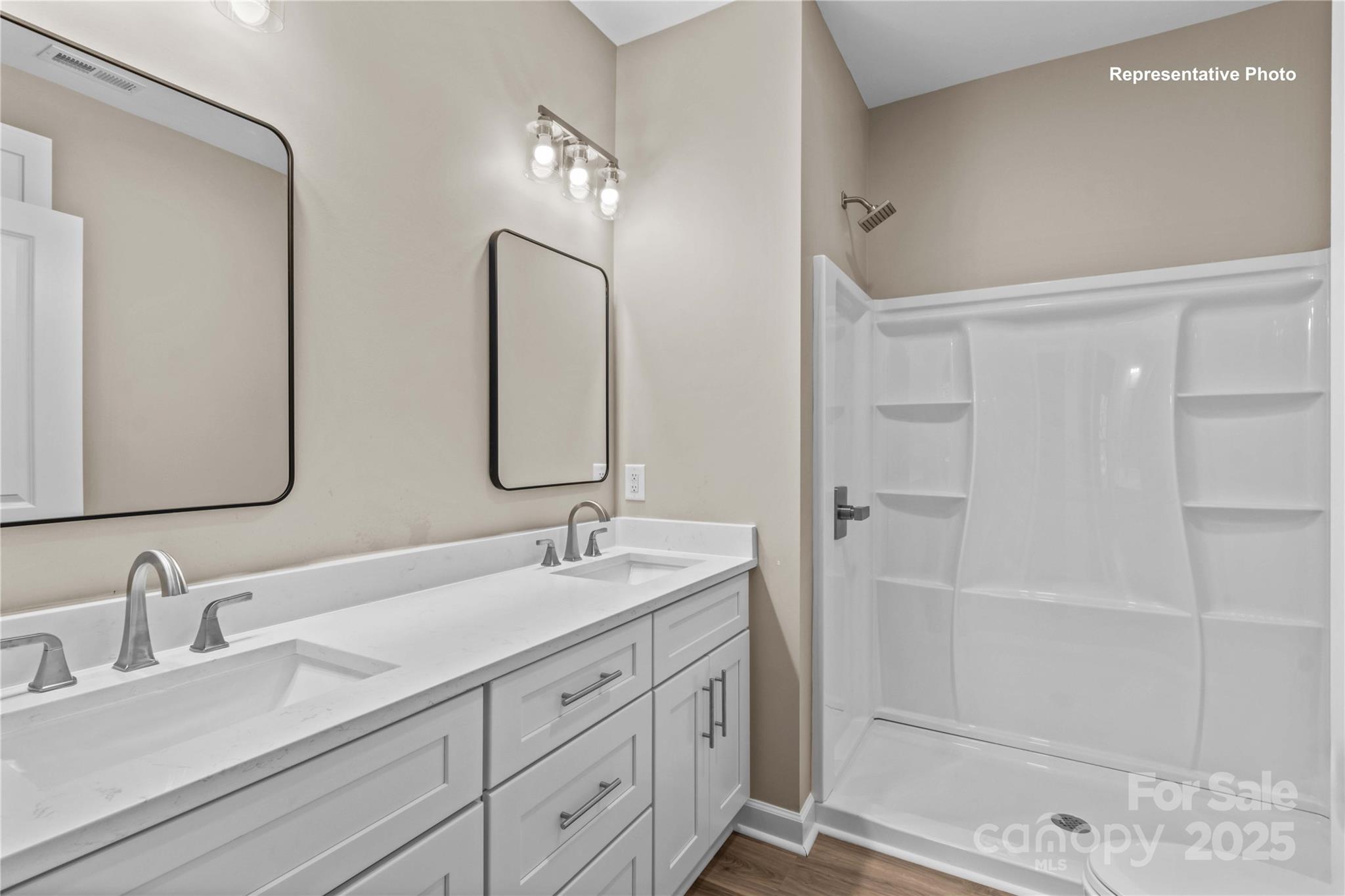 986 Tabor Road Olin, NC 28660 - Photo 16 of 27 a bathroom with double vanity sinks and a mirror