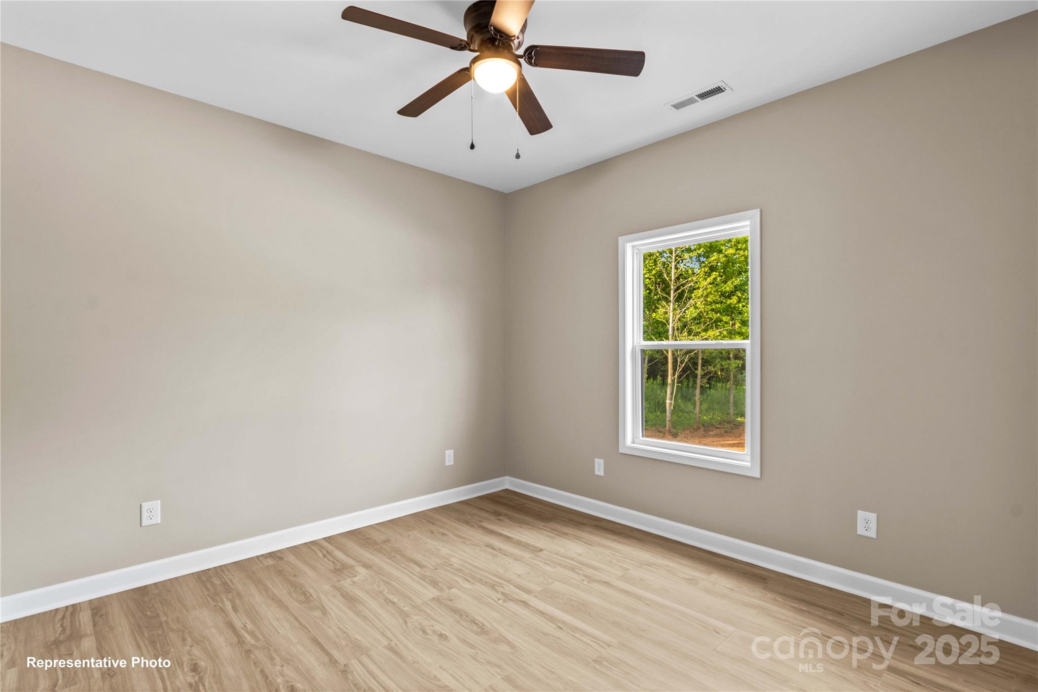 986 Tabor Road Olin, NC 28660 - Photo 19 of 27 an empty room with a window and a fan