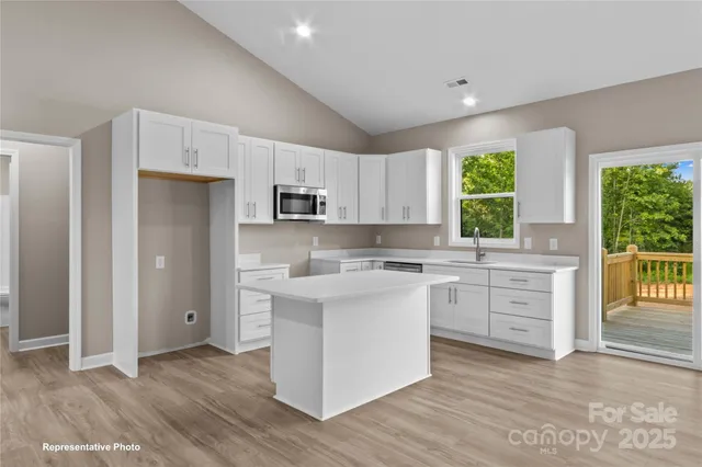 a kitchen with white cabinets and white appliances