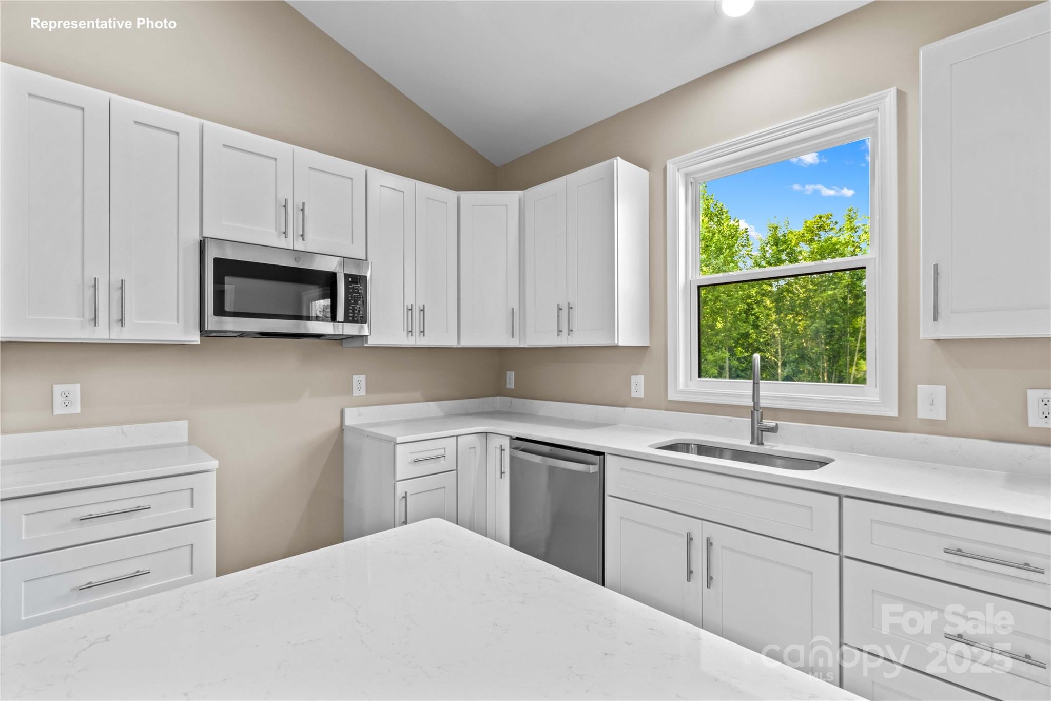986 Tabor Road Olin, NC 28660 - Photo 10 of 27 a kitchen with white cabinets appliances a sink and a window