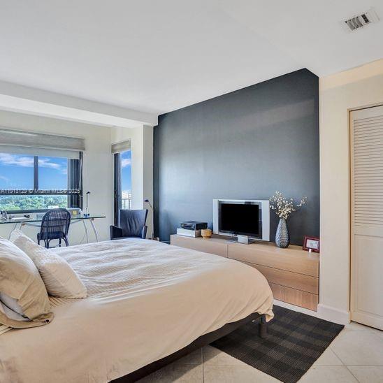 151 Crandon Boulevard, Unit 1130 Key Biscayne, FL 33149 - Photo 14 of 39 a bedroom with a bed and a view of kitchen