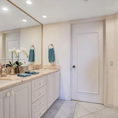 a bathroom with a double vanity sink and mirror