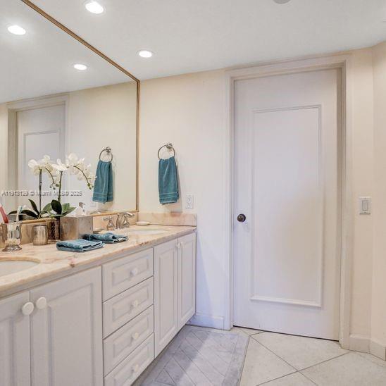151 Crandon Boulevard, Unit 1130 Key Biscayne, FL 33149 - Photo 15 of 39 a bathroom with a double vanity sink and mirror
