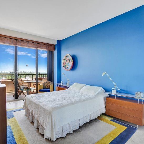 151 Crandon Boulevard, Unit 1130 Key Biscayne, FL 33149 - Photo 17 of 39 a bed sitting in a bedroom next to a window