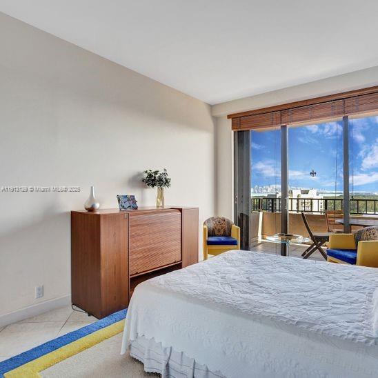 151 Crandon Boulevard, Unit 1130 Key Biscayne, FL 33149 - Photo 18 of 39 a bedroom with a bed and a large window