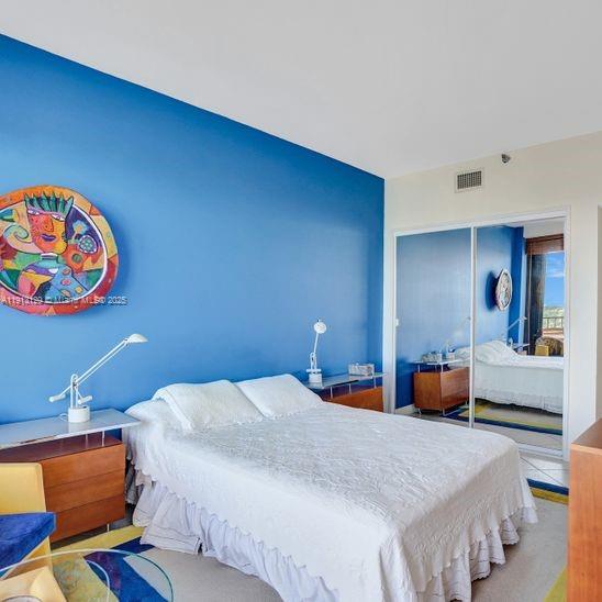 151 Crandon Boulevard, Unit 1130 Key Biscayne, FL 33149 - Photo 19 of 39 a bedroom with a bed and wooden floor