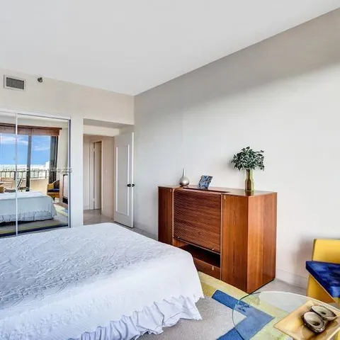 a bedroom with bed and wooden floor