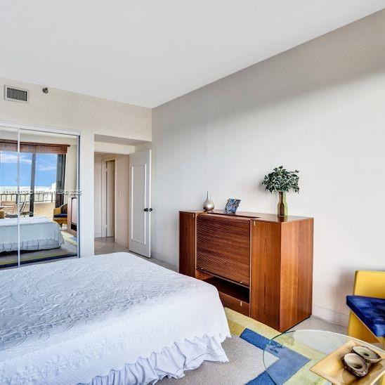 151 Crandon Boulevard, Unit 1130 Key Biscayne, FL 33149 - Photo 20 of 39 a bedroom with bed and wooden floor