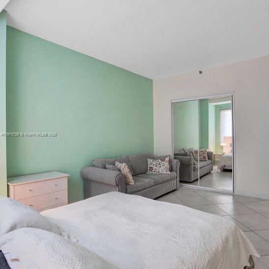 151 Crandon Boulevard, Unit 1130 Key Biscayne, FL 33149 - Photo 26 of 39 a bedroom with a bed and furniture